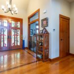 Inviting foyer with hardwood floors and custom stained glass doors inside 5841 Willow Springs Way, listed by Andi Dyer