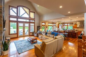 Open concept living room with modern furnishings and view into the gourmet kitchen at 5841 Willow Springs Way, listed by Andi Dyer