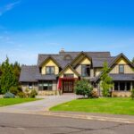 Street view of spacious home at 5841 Willow Springs Way featuring lush landscaping and a welcoming red door, listed by Andi Dyer