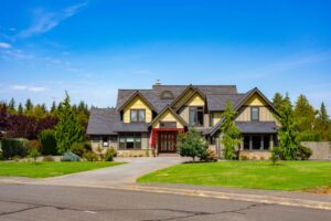 Street view of spacious home at 5841 Willow Springs Way featuring lush landscaping and a welcoming red door, listed by Andi Dyer