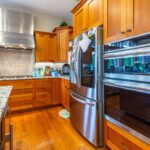 Close-up view of the kitchen's working area with high-end appliances and ample counter space, listed by Andi Dyer