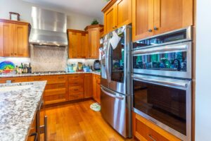 Close-up view of the kitchen's working area with high-end appliances and ample counter space, listed by Andi Dyer