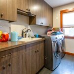 Functional laundry room with modern appliances and ample cabinet space, listed by Andi Dyer