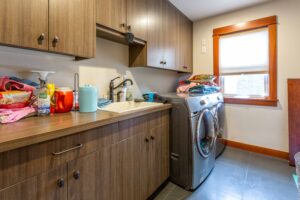 Functional laundry room with modern appliances and ample cabinet space, listed by Andi Dyer