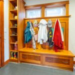 Functional mudroom with built-in storage solutions adjacent to the kitchen, listed by Andi Dyer