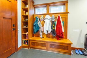 Functional mudroom with built-in storage solutions adjacent to the kitchen, listed by Andi Dyer