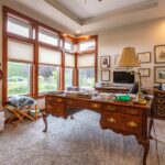 Cozy home office featuring traditional furniture and a serene garden view, listed by Andi Dyer