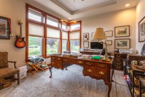 Cozy home office featuring traditional furniture and a serene garden view, listed by Andi Dyer