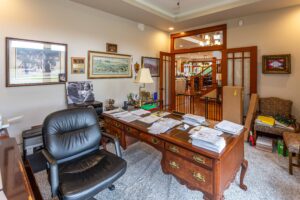 Elegant home office with classic wood furniture and open layout to the rest of the home, listed by Andi Dyer