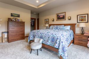 Another view of the primary bedroom showcasing additional space and storage, listed by Andi Dyer